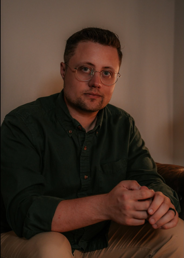 Caleb Andrew seated in a warmly lit room