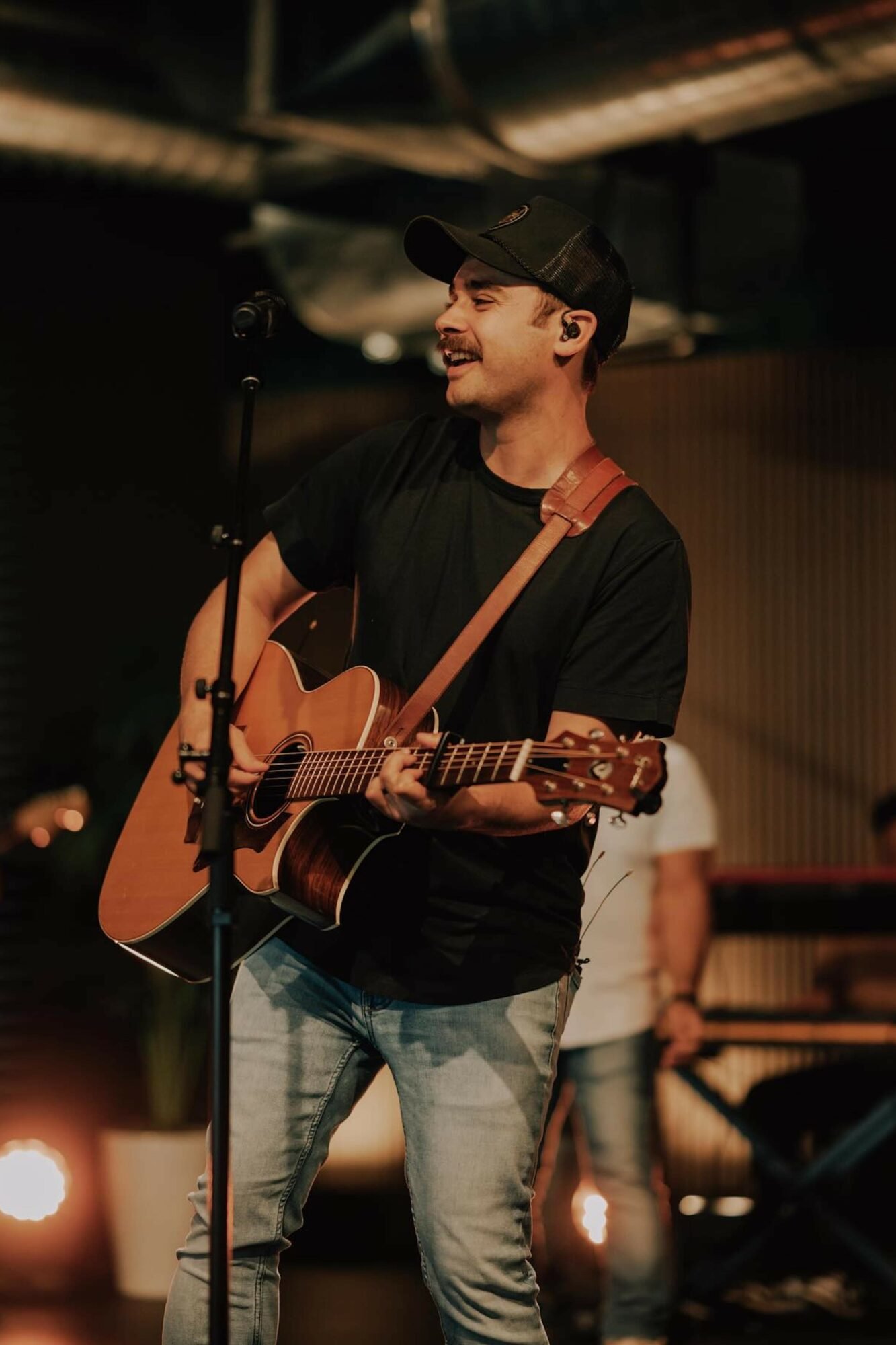 Josh Bissell leading worship with an acoustic guitar